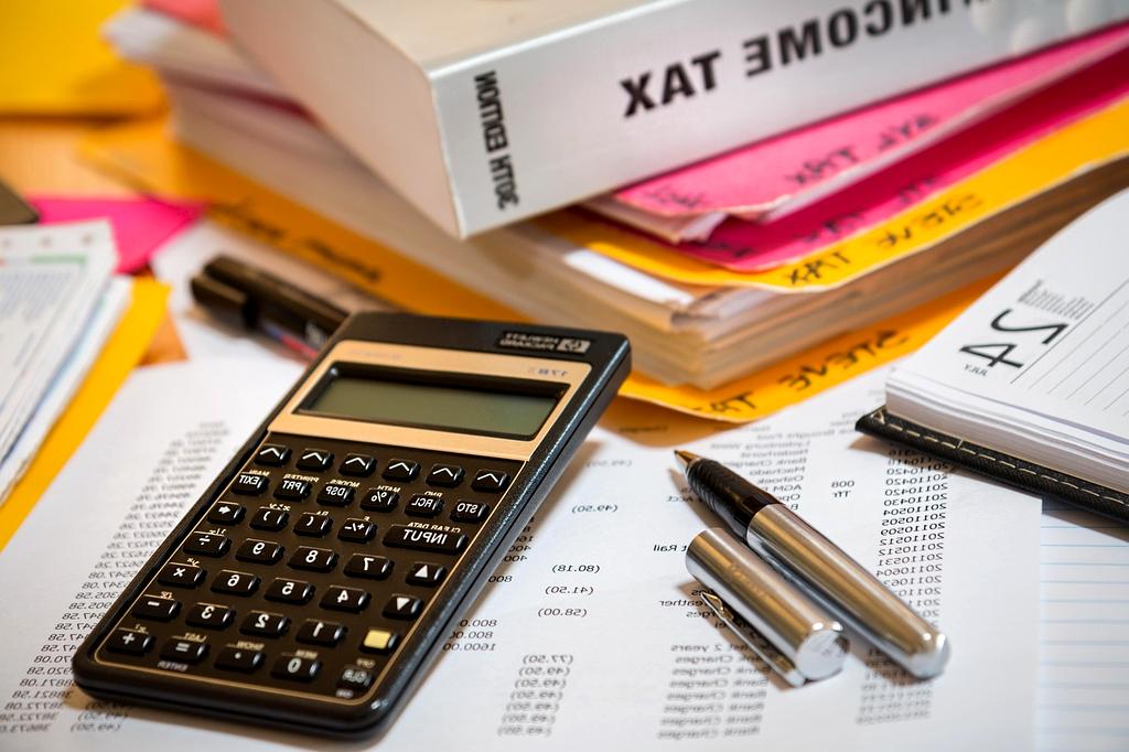 Close up of debt reduction plan with red pen striking out amounts