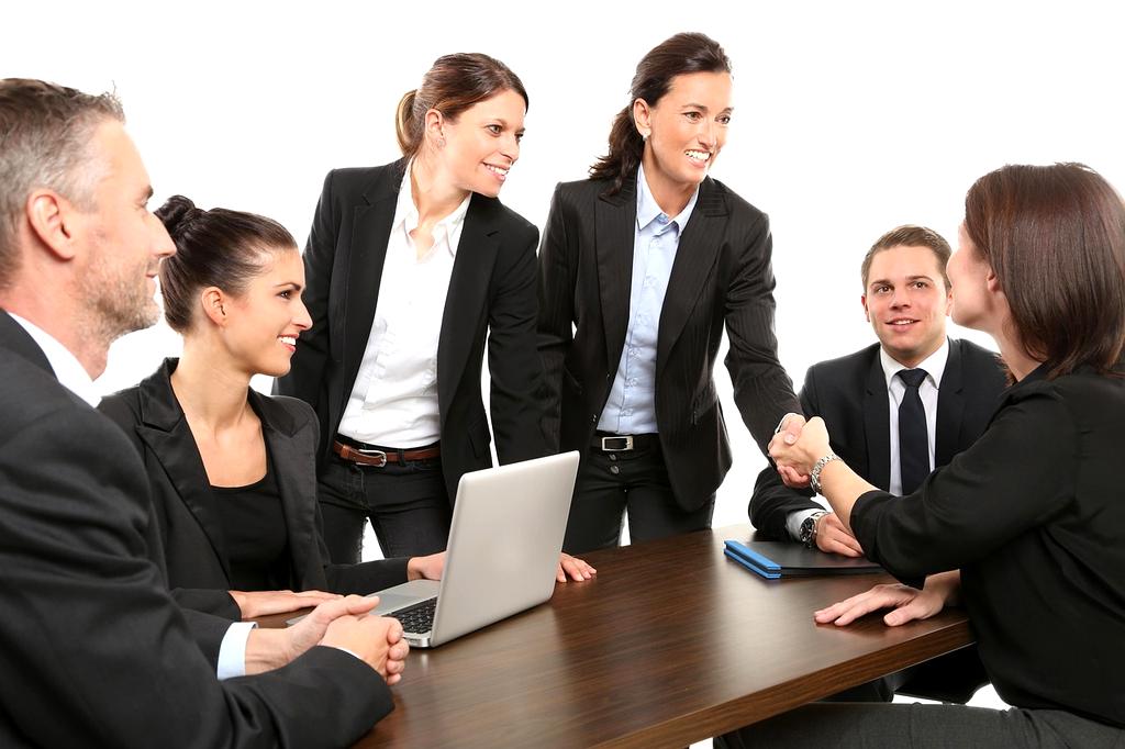 Financial advisors meeting with clients in a modern office